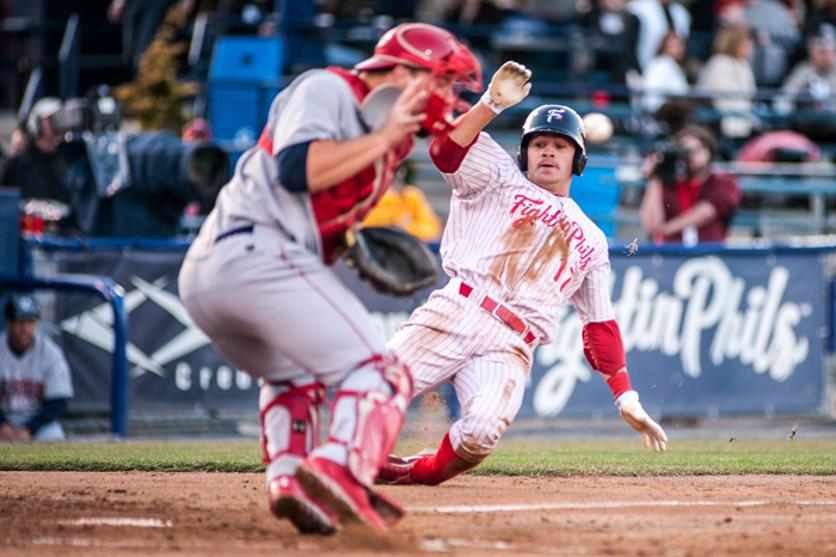 Carlos Alonso sliding toward home plate while playing professional baseball